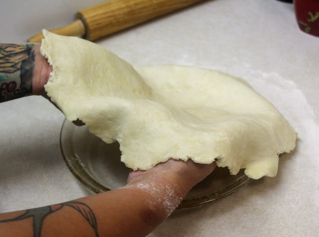 hands holding pie crust